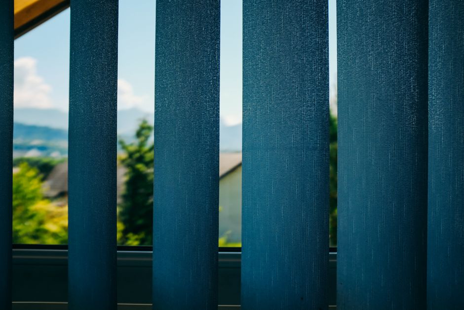 Sunlight streaming through elegant window blinds